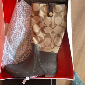 Brown and Tan coach rain boots warn three times